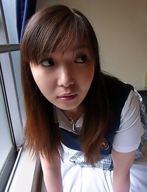 Haruka Ohsawa posing in her schoolgirl uniform and hiking up her top to show her big boobs