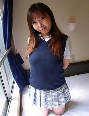 Haruka Ohsawa posing in her schoolgirl uniform and hiking up her top to show her big boobs
