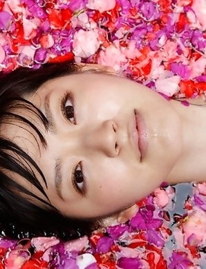 Airi Suzuki in bath suit enjoys petals all over her body