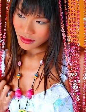 Ling Ling is wearing her white lingerie and she is standing next to the pearl curtain and posing for your eyes.