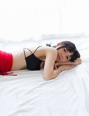 Natsuki Yokoyama posing in a red skirt with black stockings, showing her ass